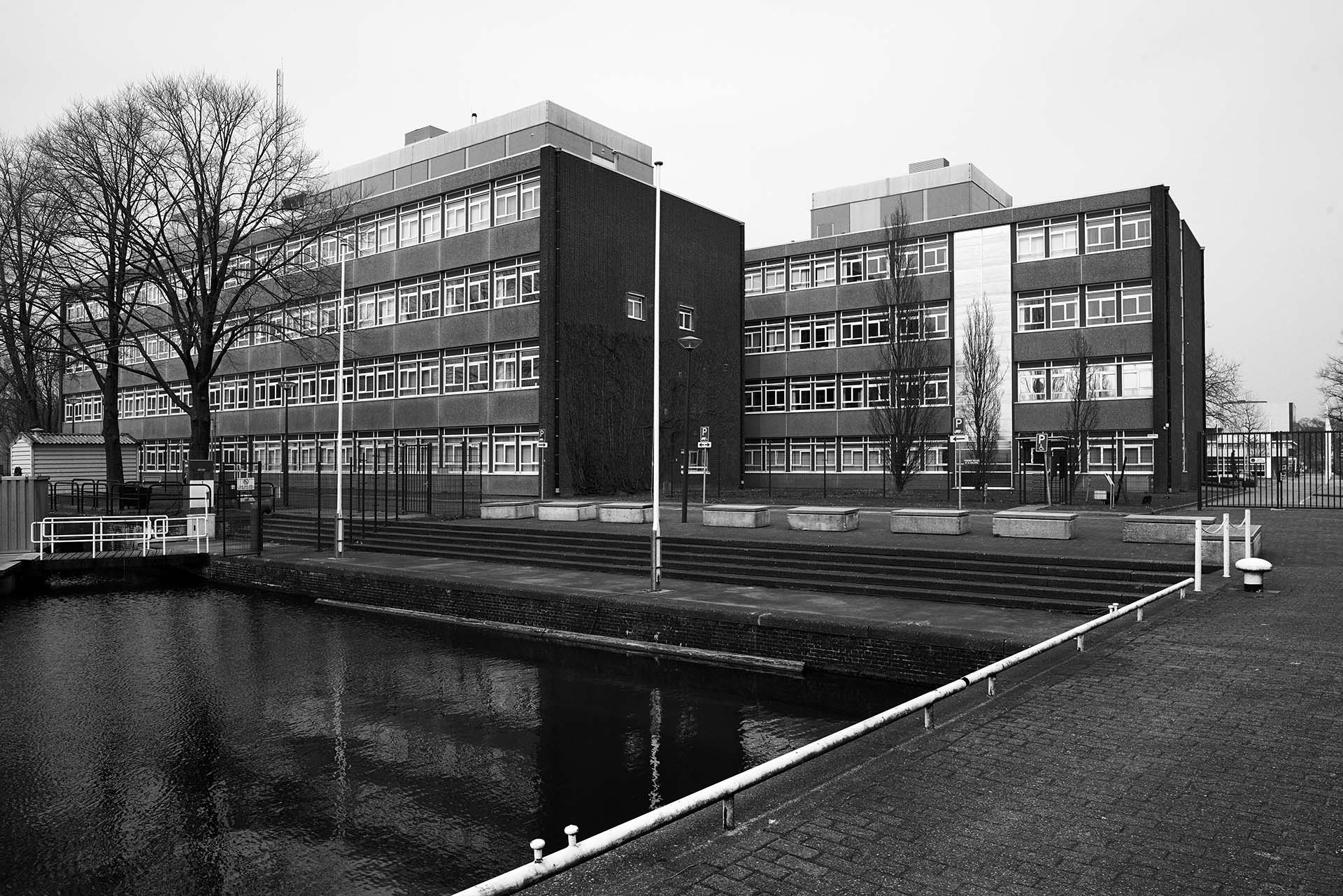 Canal near modern buildings on street